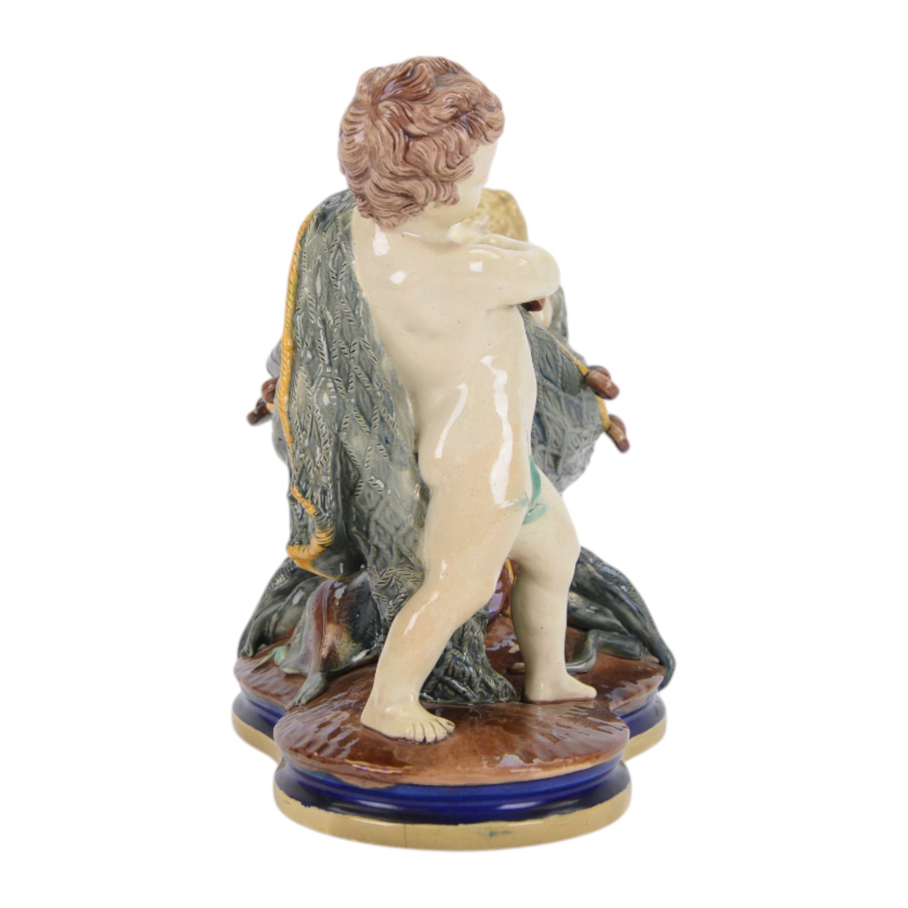 Late 19th century Copeland majolica centrepiece, circa 1874, modelled as two putto standing with fishing net draped between them, their catch spilling onto the quatrelobed base beneath, with impressed mark beneath, H24cm W33cm 