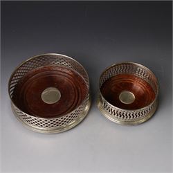 Two silver mounted bottle coasters, the larger example with latticework sides, hallmarked Mappin & Webb Ltd, Birmingham 1993, the smaller example with pierced sides, hallmarked W I Broadway & Co, Birmingham 1998, largest D12cm