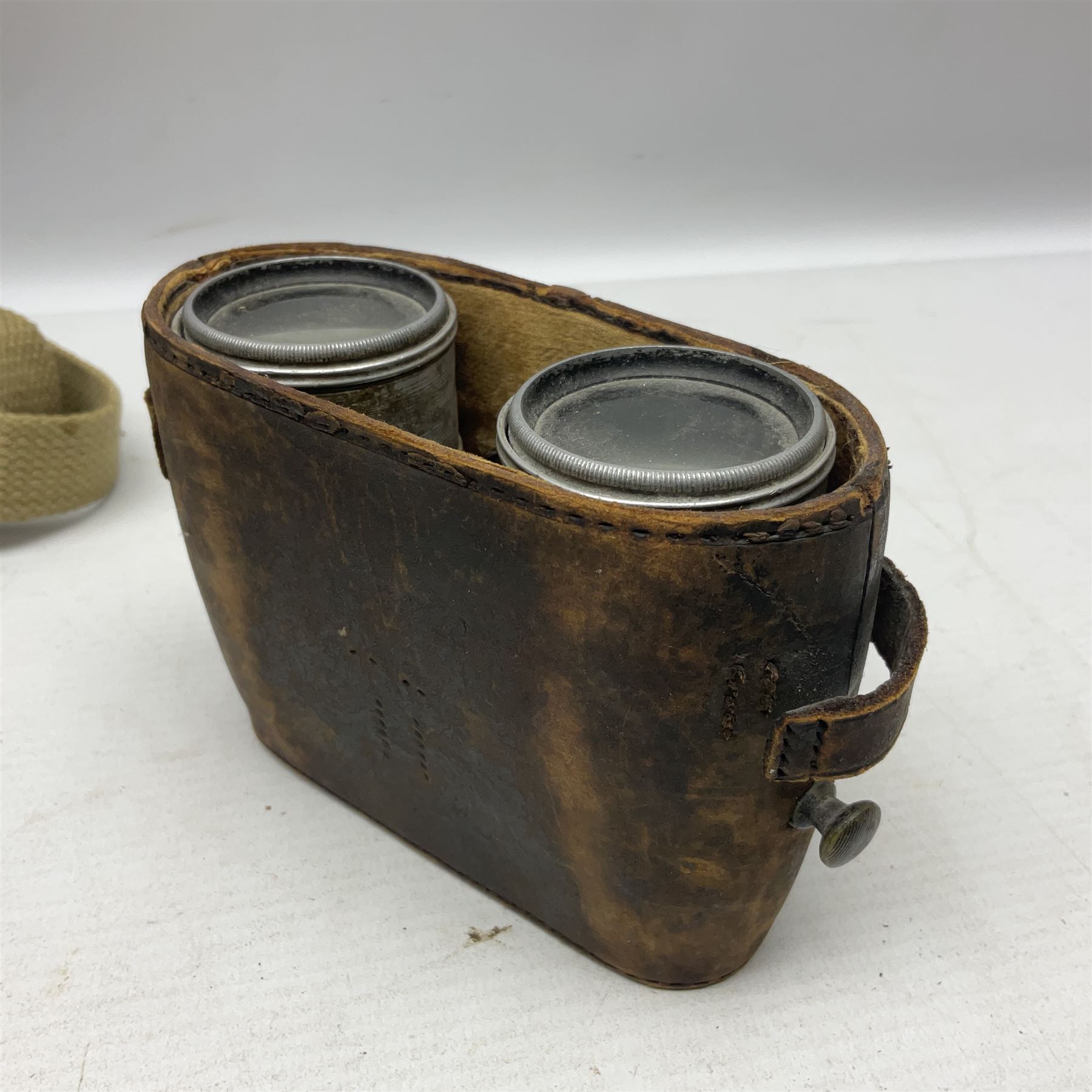 Mundial Brazil bowie knife, the 15.5cm steel blade inscribed 'Sheriff Knife', with banded and aluminium hilt; in leather sheath L29cm overall; British Army felt covered metal water bottle with webbing strap; leather 12-bore cartridge belt; and small pair of non-military binoculars in part case (4)