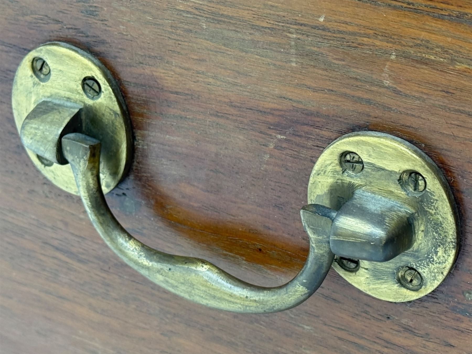 Zanzibar chest, early 20th century, of hardwood construction with brass inlaid foliate and geometric decoration to the lid, fitted interior of multiple carved compartments, with brass strapwork, side handles, and shaped bracket feet