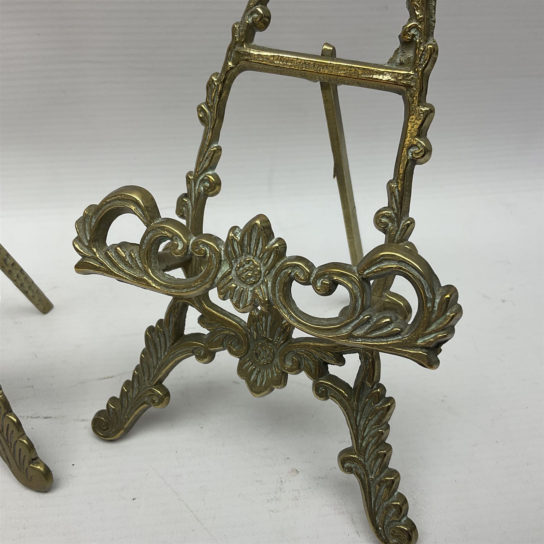 Nine ornate cast brass easel stands of various sizes, H24cm