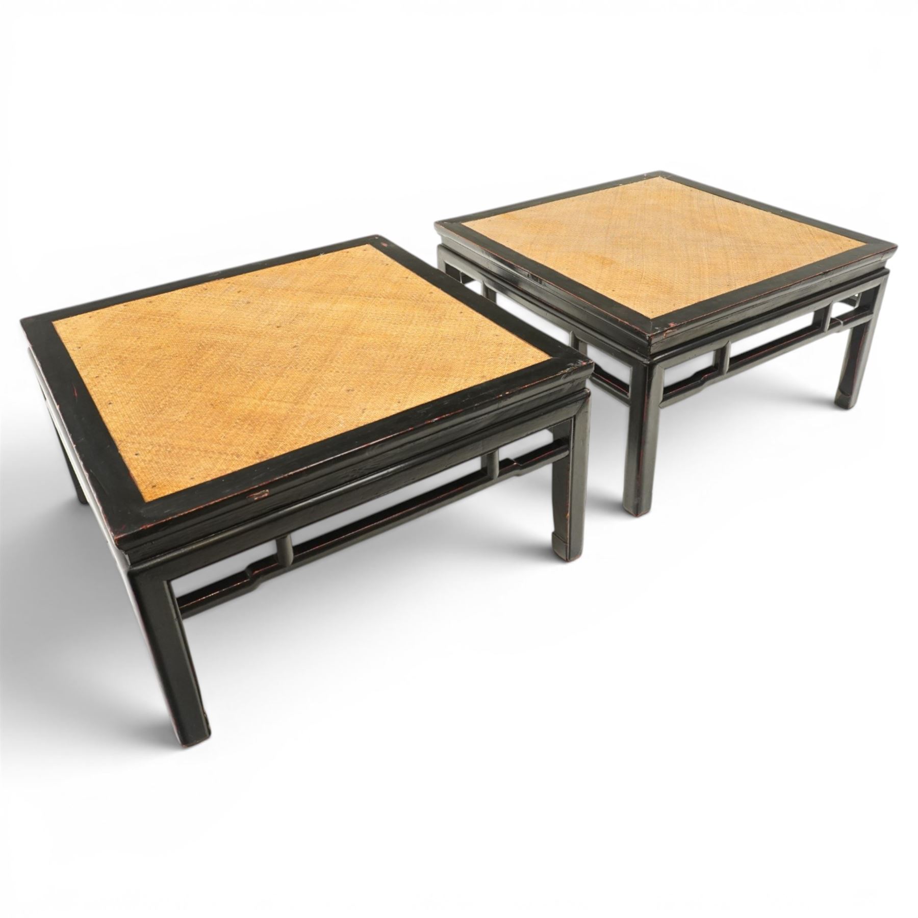 Pair of 20th century Chinese lacquered low coffee or lamp tables, square top with inset woven panel, over shaped frieze rails, raised on moulded square supports