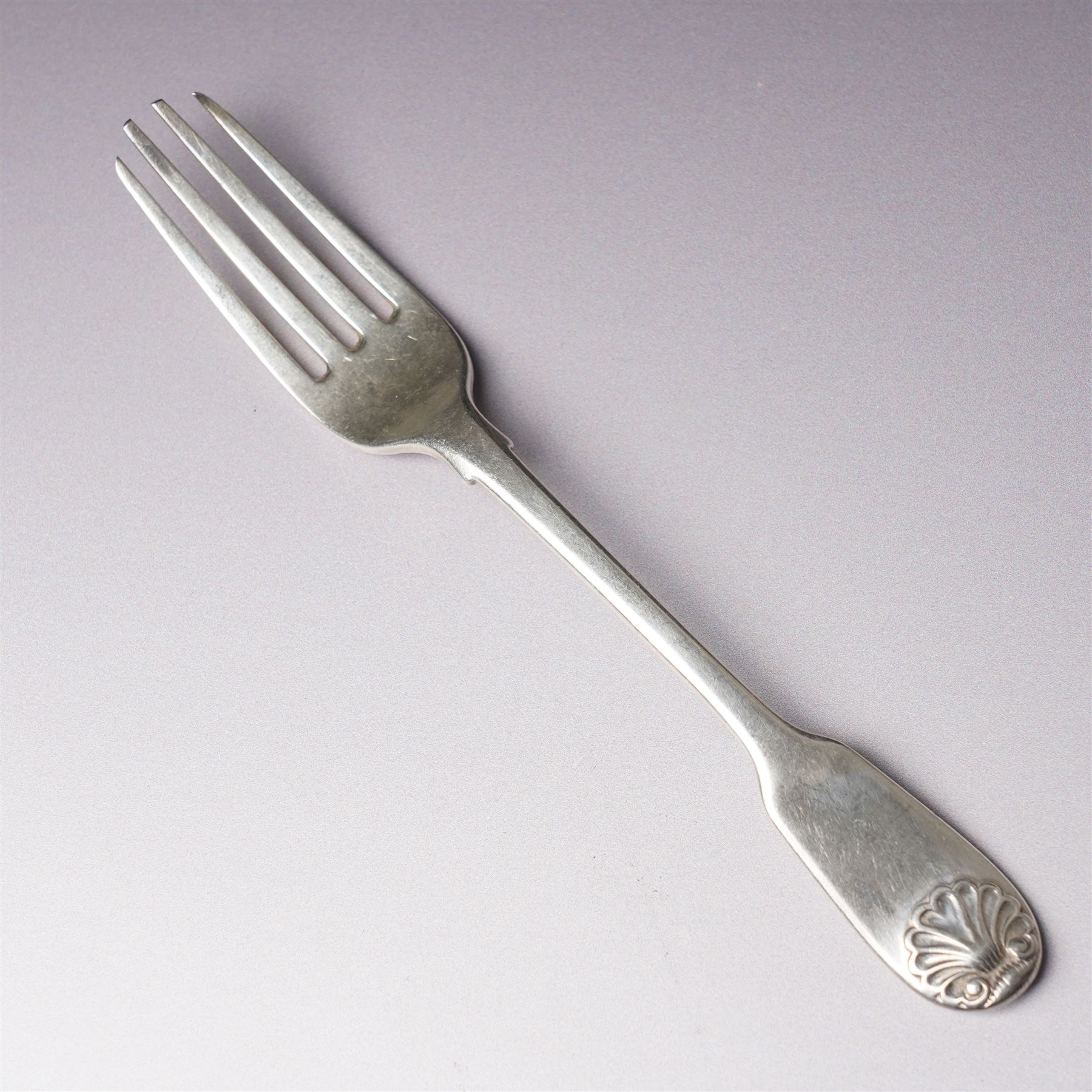 Four Victorian silver dessert spoons engraved with initials Exeter 1877 Maker Josiah Williams & Co and four George IV silver fiddle and shell pattern dessert forks London 1828 Maker William Chawner 