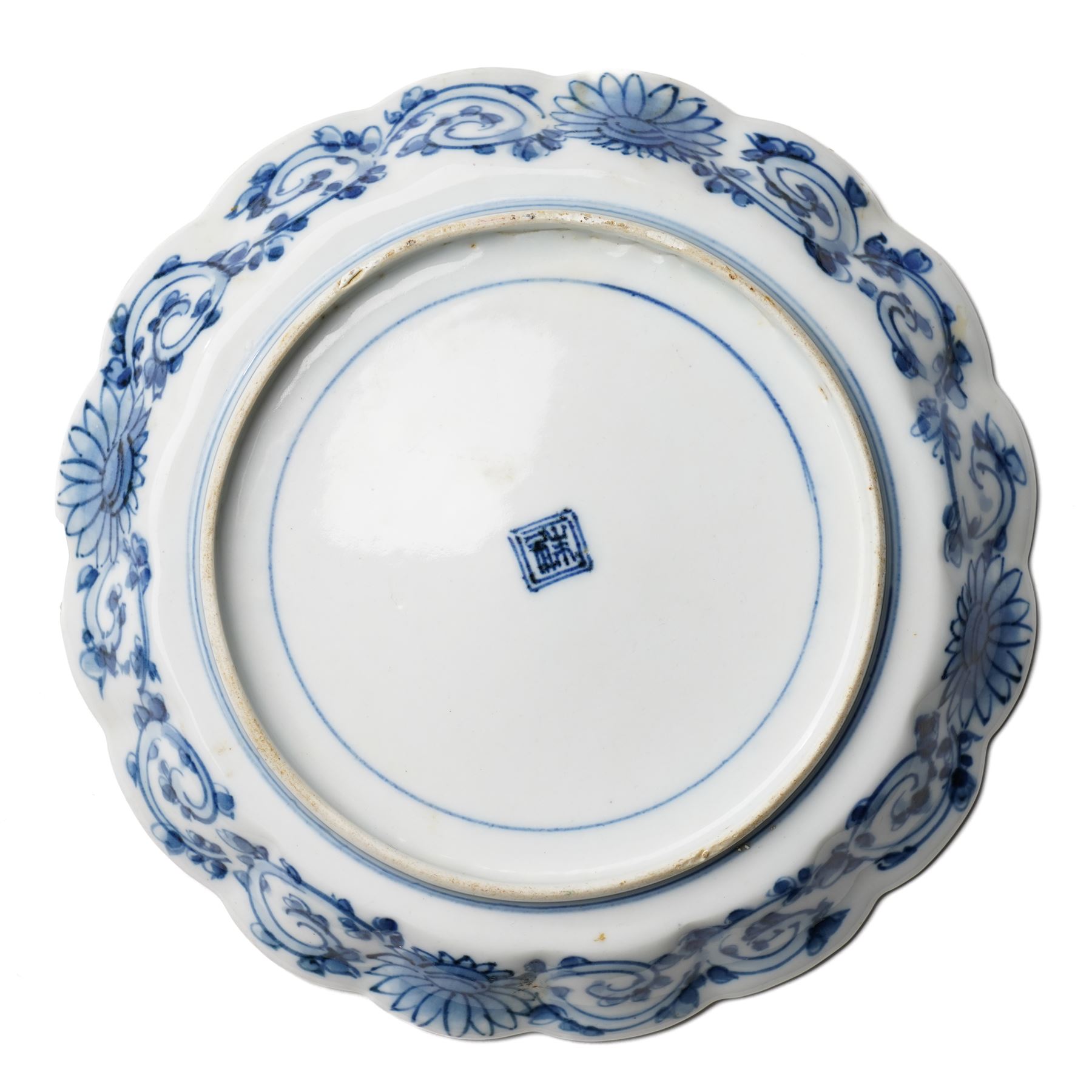 Pair of Japanese Edo period Ko Kutani dishes, decorated in green, yellow, blue iron-red, and aubergine enamels, the centres painted with a singing bird perched on a rock among foliage, within a border of alternating geometric designs and a chocolate-brown rim, the reverse with underglaze blue foliage, Fuku mark, D20.8cm (2) A matching pair of dishes is held in the collection of the Cleveland Museum of Art (see accession no. 1964.262)