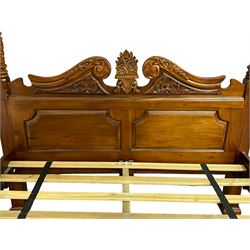 Georgian design mahogany 5' King-size four-poster bed, projecting moulded canopy top on twist-turned columns carved with acanthus leaves and flower heads, the headboard with scrolled broken swan neck pediment carved with scrolled foliage and with central anthemion, on flower head carved ball and claw front feet, with torch and foliate carved pointed finials
