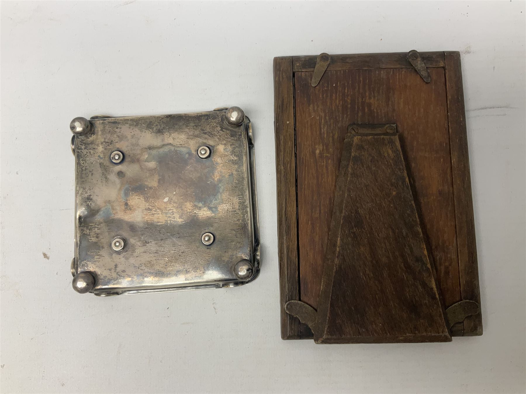 Edwardian silver stand, of square shaped form, upon four bun feet, hallmarked Birmingham 1907, together with an early 20th century silver mounted photograph frame, hallmarked Birmingham 1918, approximate weighable silver 93.6 grams