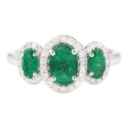 Platinum emerald and diamond trilogy ring, three oval cut emeralds surrounded by round bri...