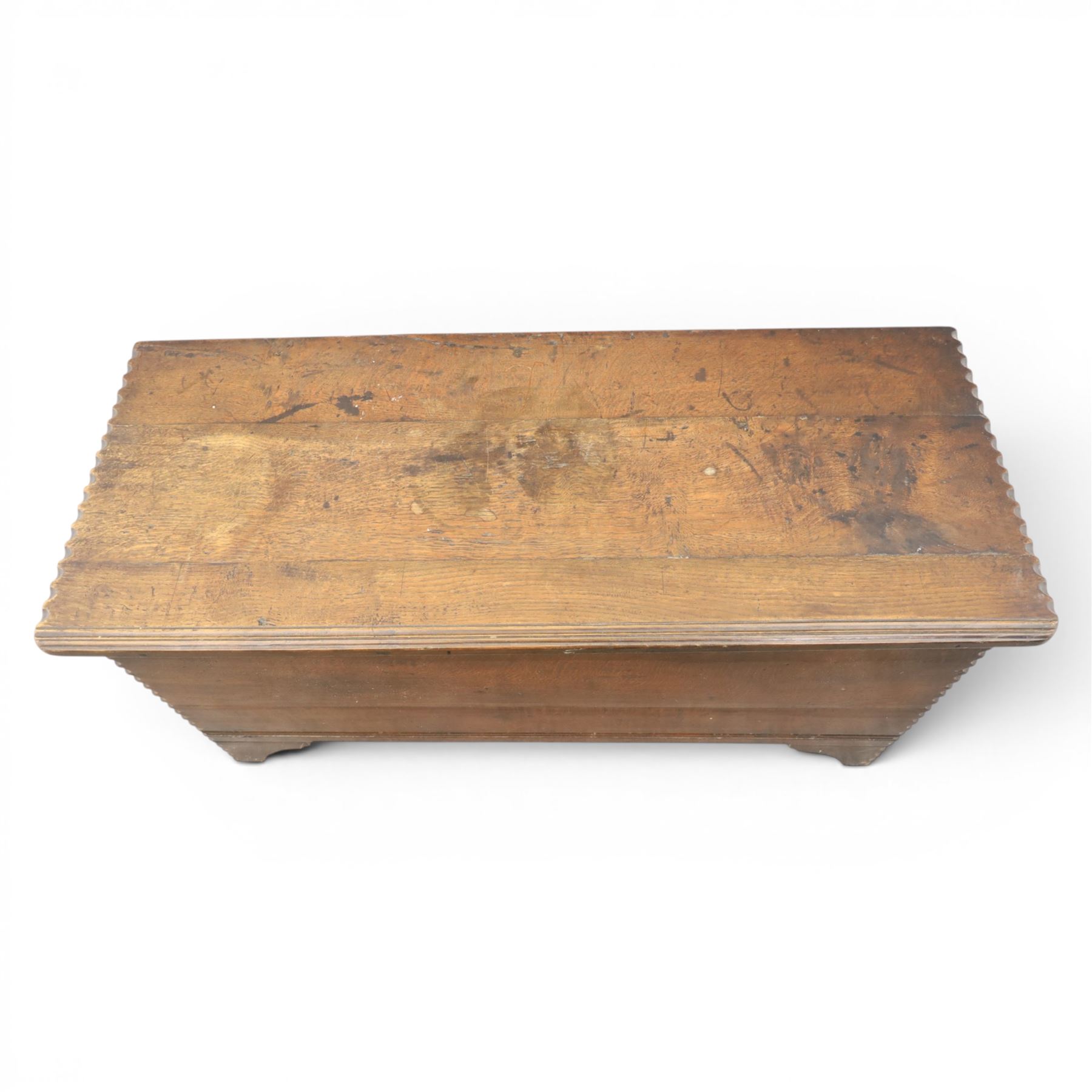 19th century oak boarded blanket box, with chip-carved edges, raised on shaped cut away bracket supports