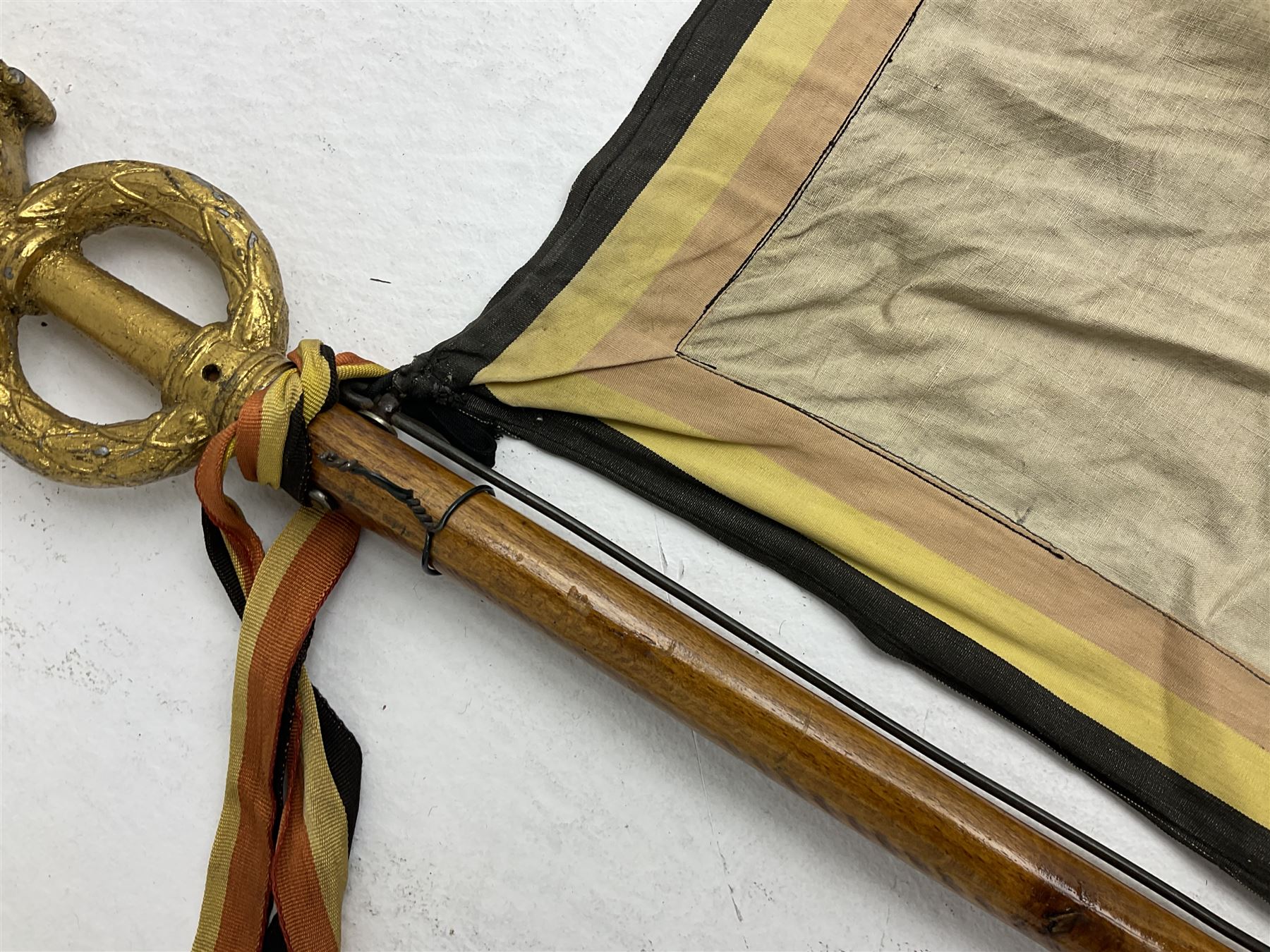 WW2 Belgian Partisan/Resistance two-sided banner embroidered in black on a cream ground 'Belgische Partisanen Korps 032 afd: Ph: De Bruyne' within a Belgian flag border; on wooden pole with gilded metal lion and laurel wreath finial