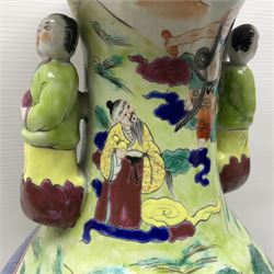 20th century Chinese Famille Rose vase, of baluster form with flared lobed rim and twin figural handles, decorated in polychrome enamel with figures dancing and playing instruments within a garden setting, H42cm