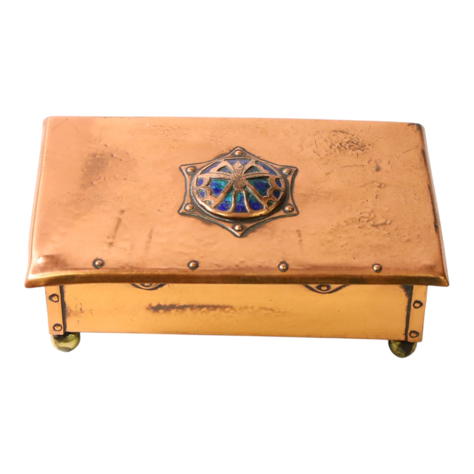  Arts & Crafts copper and enamel box, of rectangular form, the hinged lid with central enamel cabochon overlaid with pierced copper butterfly motif, raised on brass bun feet, H7cm, L17cm