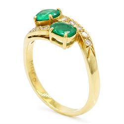 18ct gold emerald and diamond crossover ring, set with five round brilliant cut diamonds and two oval cut emerald finials, Sheffield 1989, total emerald weight approx 0.40 carat