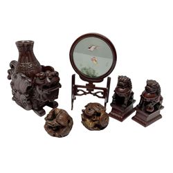 Group of carved Chinese carved wood and composite items, to include temple lion with vase upon its back, pair of temple lions on stands, two spheres, one carved with dragon, and a small screen