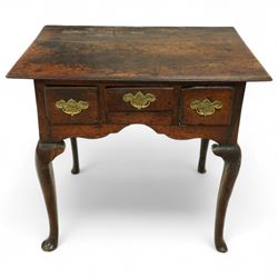 18th century oak lowboy, the three frieze drawers fitted with later brass handles, over shaped apron and cabriole legs with pad feet