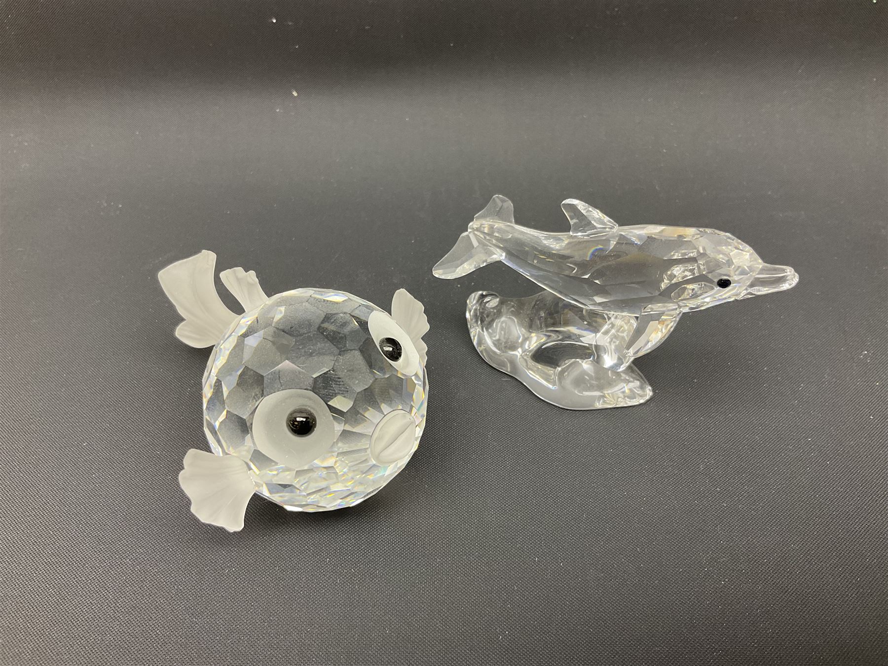 Nineteen Swarovski Crystal sea creatures, to include dolphins, seals, puffer fish, octopus, crabs, together with a quantity Swarovski Crystal shells 