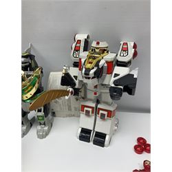 Collection of early 90s Mighty Morphin’ Power Rangers Zords, figures and accessories. Titanus the Carrier Zord, marked Bandai 1991; Green Dragonzord, incomplete; 1994 White Tigerzord with original instruction manual; 1993 Triceratops Dinozord, Mastodon Dinozord and Sabertooth Tiger Dinozord, Pterodactyl Dinozord, missing guns; with 1993 Power Morpher and original Power Coins, with further related figures, accessories and weapons