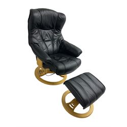 Anderssons of Sweden - mid-20th century design swivel armchair, upholstered black leather, raised on beech U-frame supports with circular base, together with matching footstool 