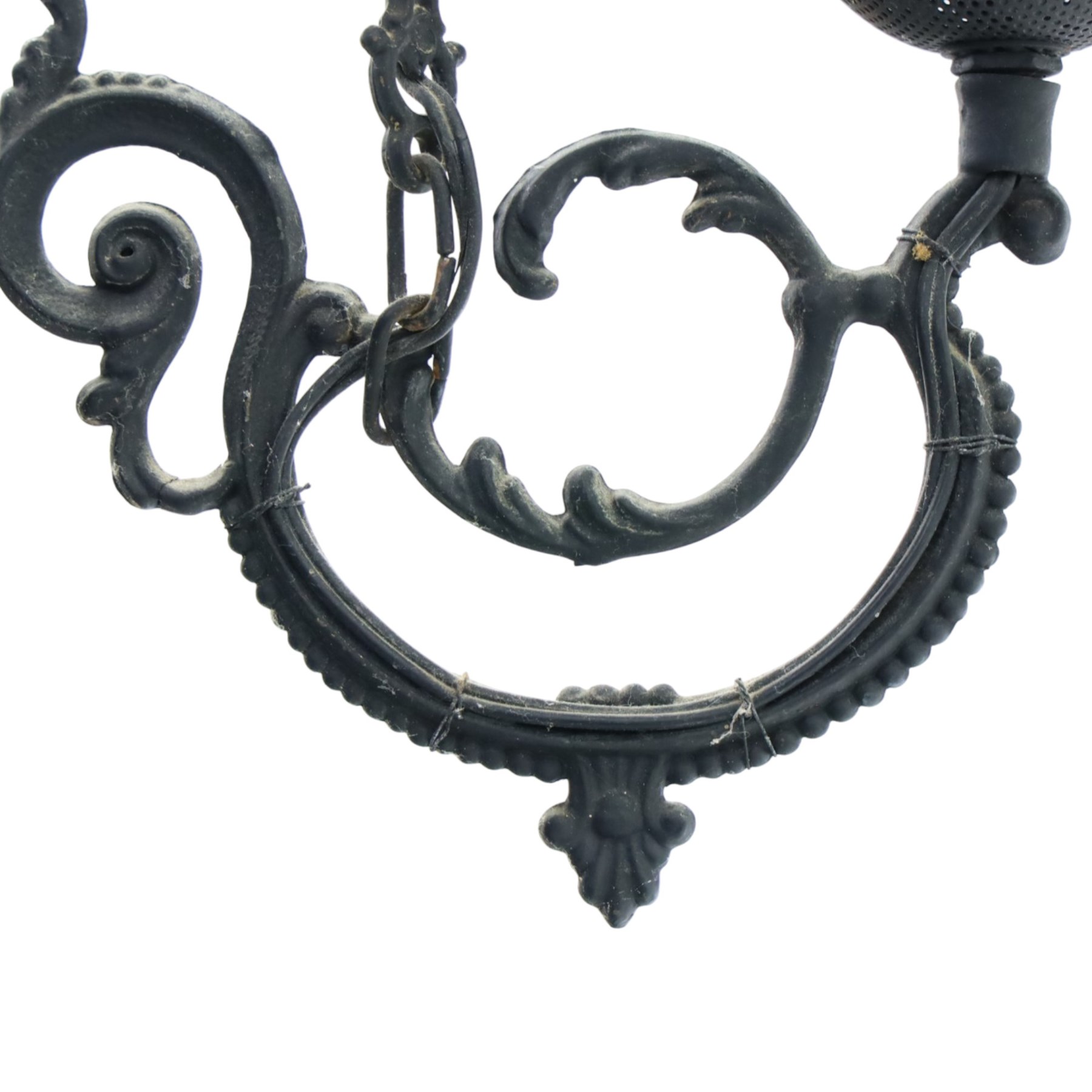Late 19th century wrought metal hanging ceiling lamp, the ornate pierced central reservoir-form body with mounted eagle, three scrolling branches fitted with three clear glass chimney shades, suspended by decorative chains from a pierced ceiling rose