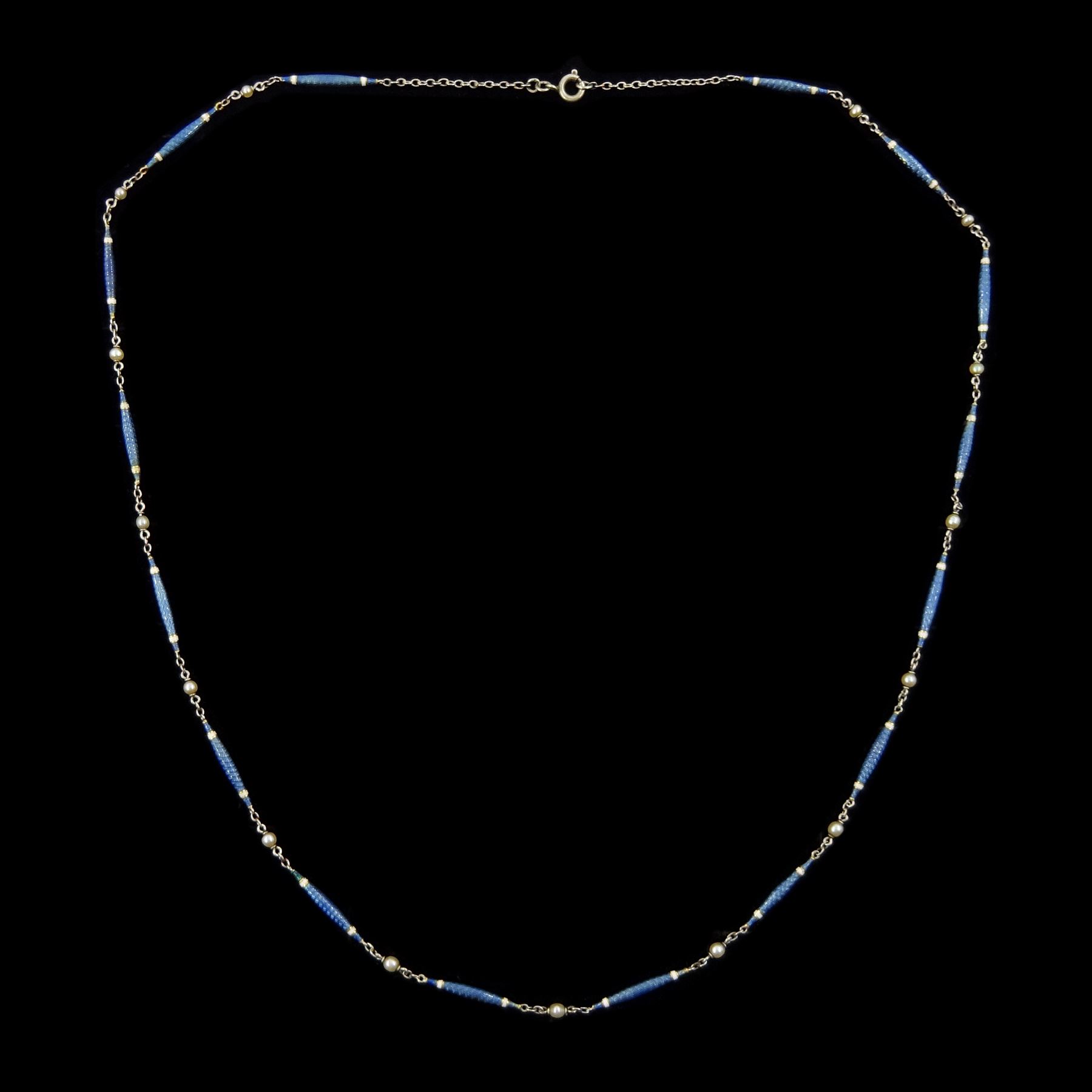 Early 20th century platinum enamel and pearl necklace, sixteen guillioche blue enamel and white enamel baton links, each spaced by a trace links and a single seed pearl