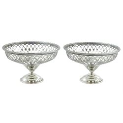 Pair of early 20th century small silver openwork footed bowls, of part pierced circular form upon domed circular feet, hallmarked Walker & Hall, Sheffield 1906 and 1912, H5.5cm D9.5cm, approximate total weight 3.18 ozt (99 grams)