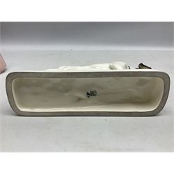 Early 20th century Katzhütte figure of a pointer dog, and figure of a young girl holding basket and fan, both with green cat H house printed mark beneath, dog L25cm