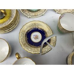 Twelve Spode Ruskin pattern coffee cups and saucers, with floral bouquets, varying colour grounds and gilt