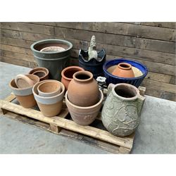 A quantity of various terracotta and glazed planters