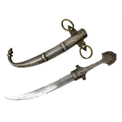 Moroccan Jambiya with 22.5cm curving steel blade, white metal and brass hilt with filigree and foliate engraved all over decoration with traces of coloured background; matching scabbard with two suspension loops L41cm overall