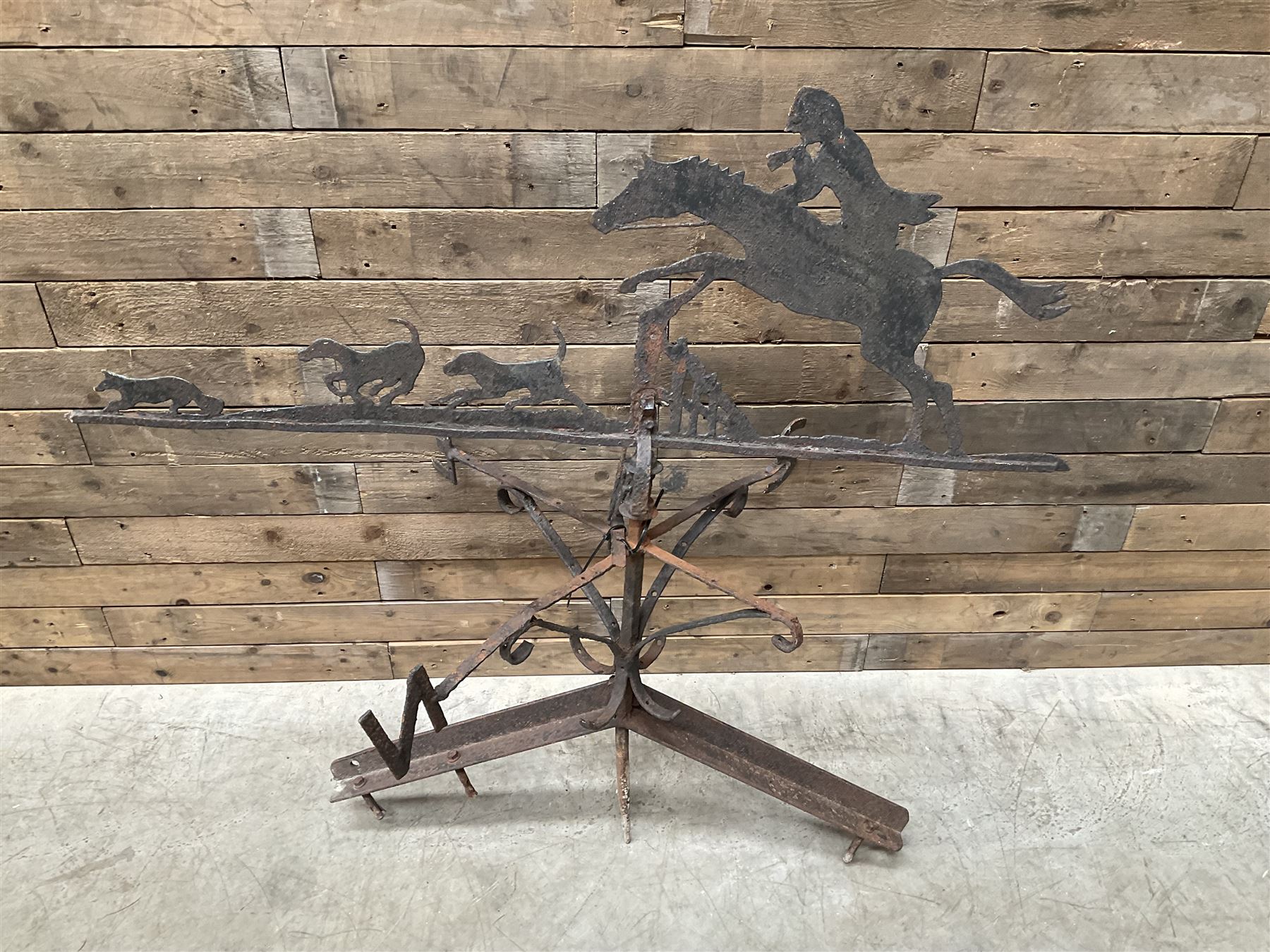 Black painted wrought iron weather-vane depicting hunting scene and compass points