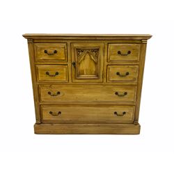 Polished pine chest, centre cupboard enclosed by six drawers