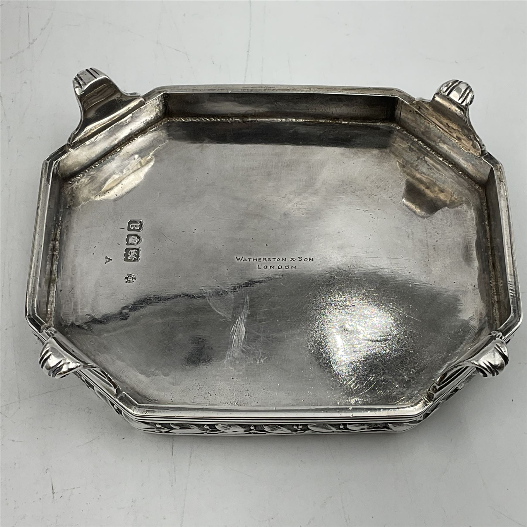 Victorian silver four piece tea service, comprising teapot, teapot stand, twin handled open sucrier and milk jug, each of octagonal form with foliate bud border and engraved decoration including crest to canted panels, and vacant panels, the teapot with ivory finial to the hinged cover and later wooden handle, hallmarked Edward Barnard & Sons Ltd, London1896, teapot including finial H15cm, milk jug including handle H16cm, teapot stand W11.5cm

This item has been registered for sale under Section 10 of the APHA Ivory Act