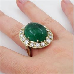 Gold emerald and diamond ring, the central oval cabochon emerald, with sixteen round and rectangular cut diamond halo surround by Judith Crowe, hallmarked 9ct, emerald 20.00 carat, total diamond weight 2.00 carat, with World Gemological Institute report