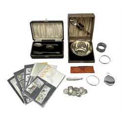 Cased silver three piece christening set, comprising fork, spoon and napkin rings, hallmarked Birmingham, together with a silver christening bangle, similar rolled gold bangle, boxed silver plated bowl and spoon, coins including various pre 1947 silver three pence pieces, etc.