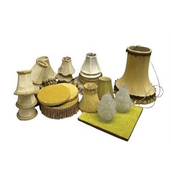 Upholster lamp/ vase stands with tassel detail, together with a selection of lampshades of various sizes 