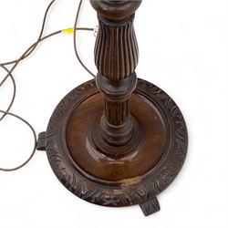 20th century mahogany floor lamp, the reeded column with carved urn knop on circular foliate moulded base, with cream fabric shade