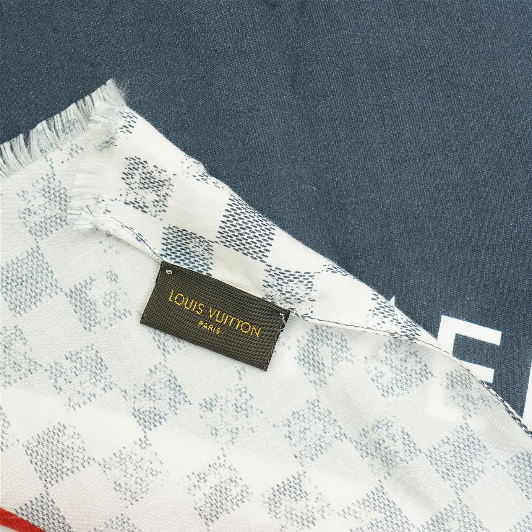 Louis Vuitton America’s Cup stole, the Damier-pattern ground with navy, red and white graphic panels, large ‘35’ motif and Louis Vuitton and America’s Cup lettering, fringed ends, label stamped Louis Vuitton Paris, 65% cotton and 35% silk, made in Italy, 201cm x 66cm