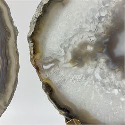 Pair of white agate slices, polished with rough edges raised upon gilt metal stands, H24cm