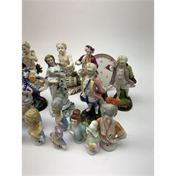 A collection of Continental porcelain pin cushion dolls, Sitzendorf figure of a girl together with other porcelain figures