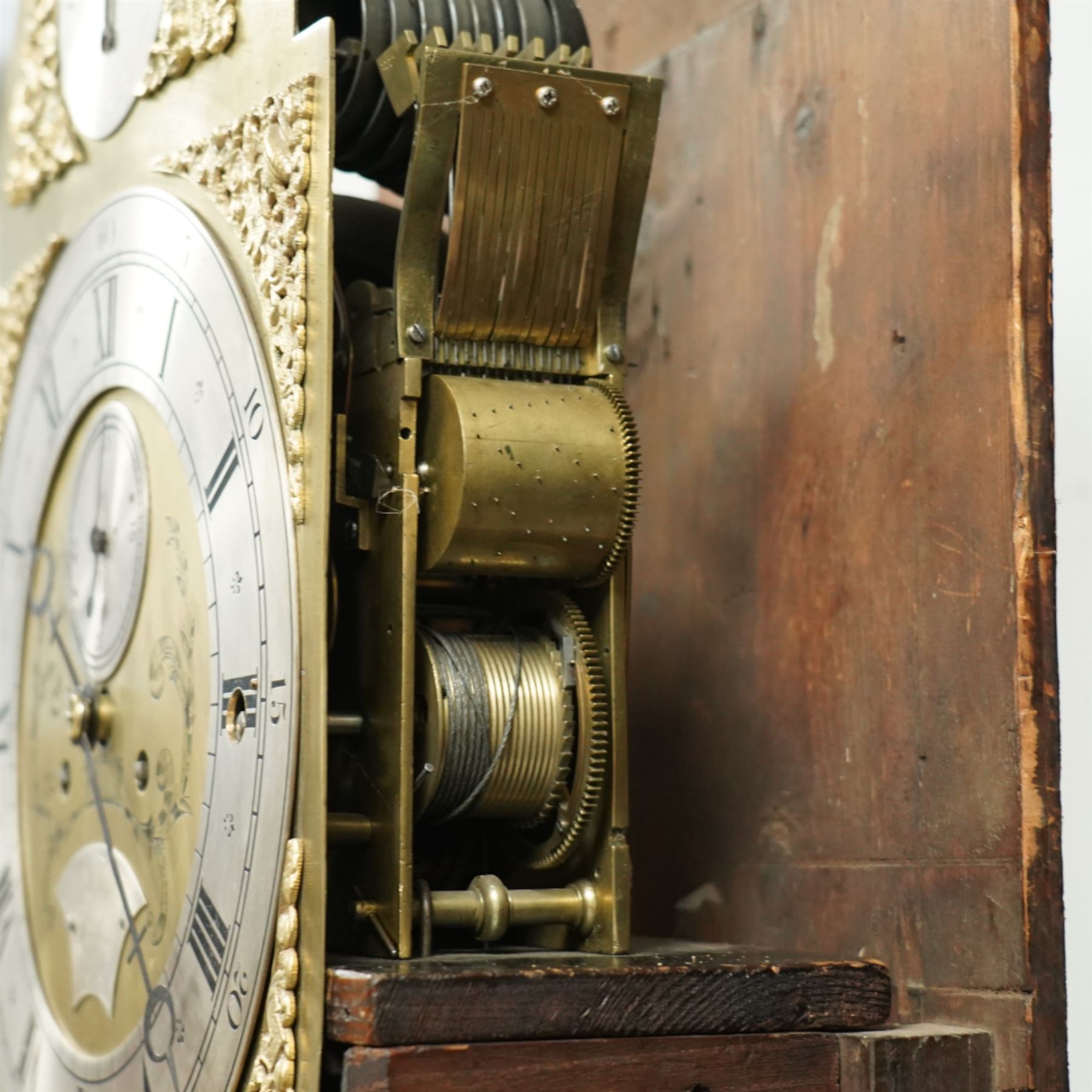 Lister of Halifax -  Oak cased musical longcase clock c1790, 8-day movement sounding the quarters and hours on bells or gong rods, case with a flat pediment and oval  conch inlay beneath, break arch hood door with reeded pilasters and brass Corinthian capitals, trunk with conforming quarter recessed pillars and a long wavy topped door, plinth with a raised panel and applied moulding the the base, break arch brass dial with cast spandrels and engraved dial centre, with a silvered chapter, seconds dial and cartouche with makers name, gongs or bells selector to the arch, chapter with Roman numerals, five minute Arabic's, minute track and steel moon hands, dial pinned directly to a three train weight driven movement with a nest of eight bells and eight gong rods, sounding the hours on either bells or gong rods, with a rack strike and recoil anchor escapement. With pendulum and weights.
The Lister family were a prodigious family of prolific clockmakers working in Halifax and the West Riding area of Yorkshire during the 18th and 19th century, well-known and noted for producing a number of chiming and musical longcase clocks.