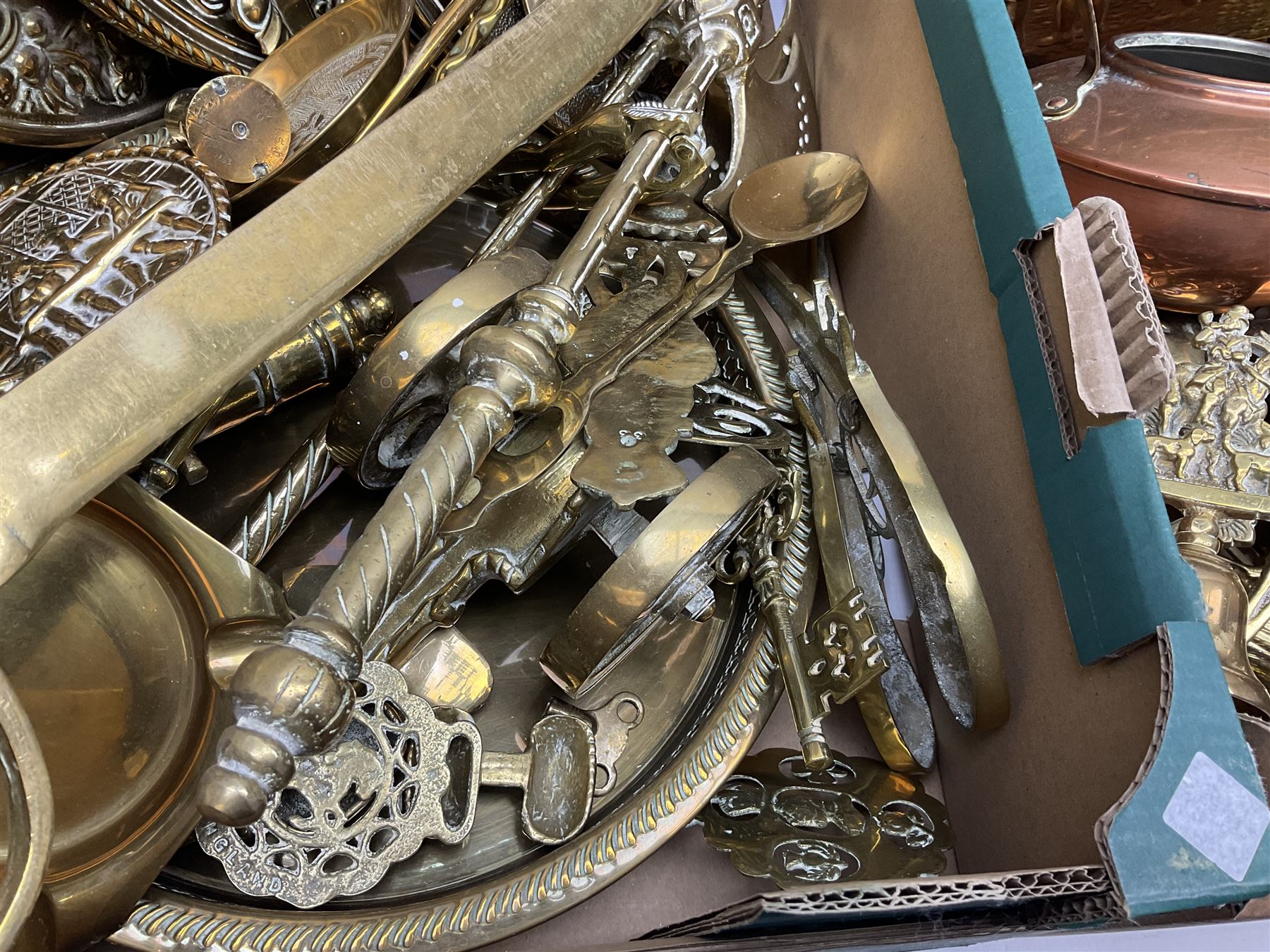 Quantity of copper pans and teapots, dish and sieve with pierced heart decoration and brass handle, together with quantity of brassware to include brass Art Nouveau crumb tray and brush, repousse chargers, fire tool accessories, decorative canon, sword and guns etc