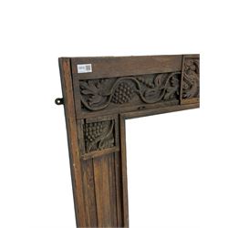 19th century Jacobean Revival oak fire surround, decorated with applied carved panels depicting foliate patterns and stylised grape vines, uprights carved with fleur-de-lis decoration
