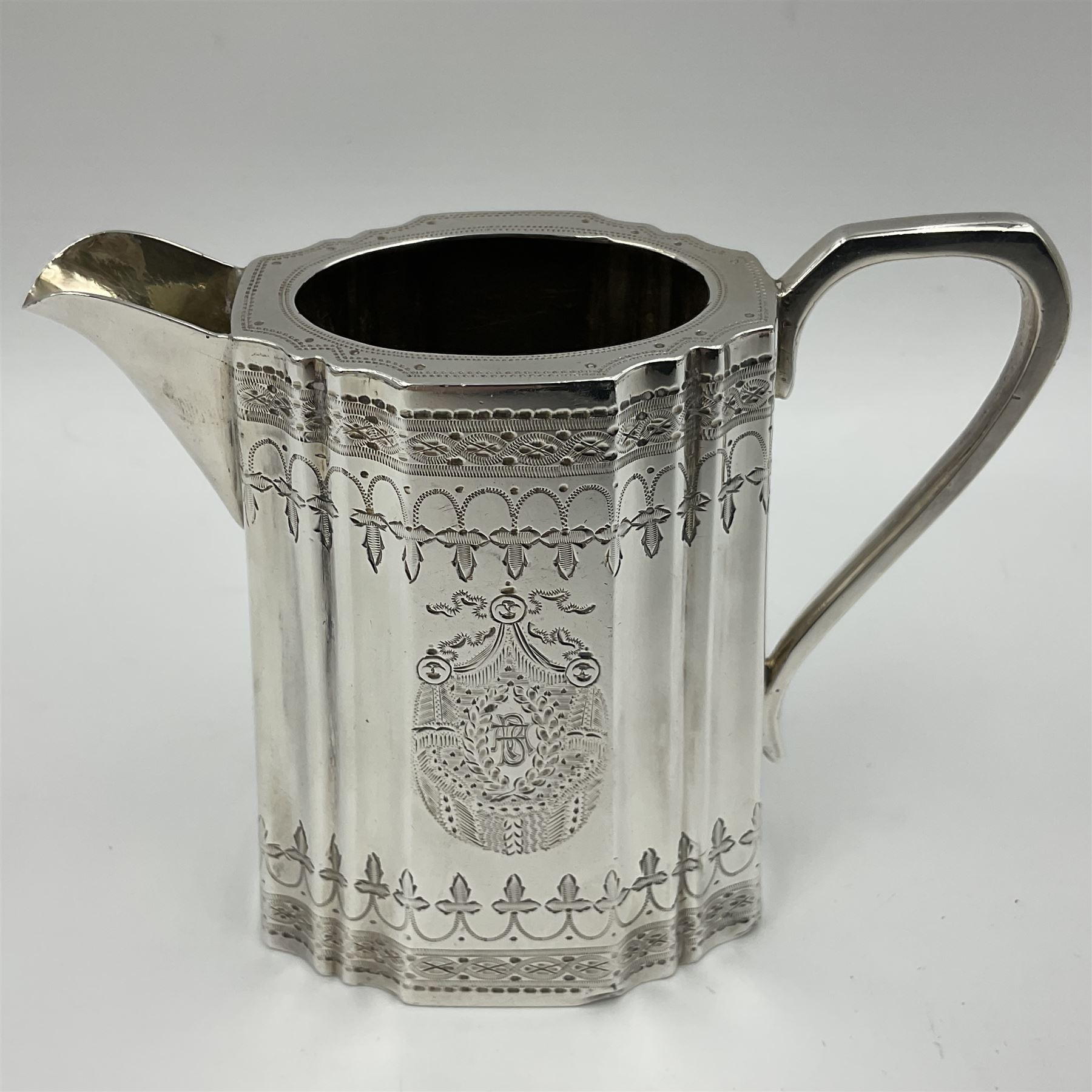 Victorian three-piece silver tea service, comprising teapot, twin handled open sucrier and milk jug, of oval form with shaped rim and C handles, each engraved with crests and bands of strapwork decoration, the milk jug and sucrier with gilt interiors, hallmarked Josiah Williams & Co, Exeter 1881, the teapot with ivory insulators and finial, all contained with a tooled leather, blue silk and velvet lined fitted case, retailed by West & Sun, Dublin 
This item has been registered for sale under Section 10 of the APHA Ivory Act