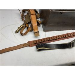 Assorted militaria including ten leather or canvas cartridge and other belts, maroon beret with 17th Lancers cap badge, modern bullet mould, leather and brass shot flask, two knives, shell cases, boomerang etc; in tin deed box