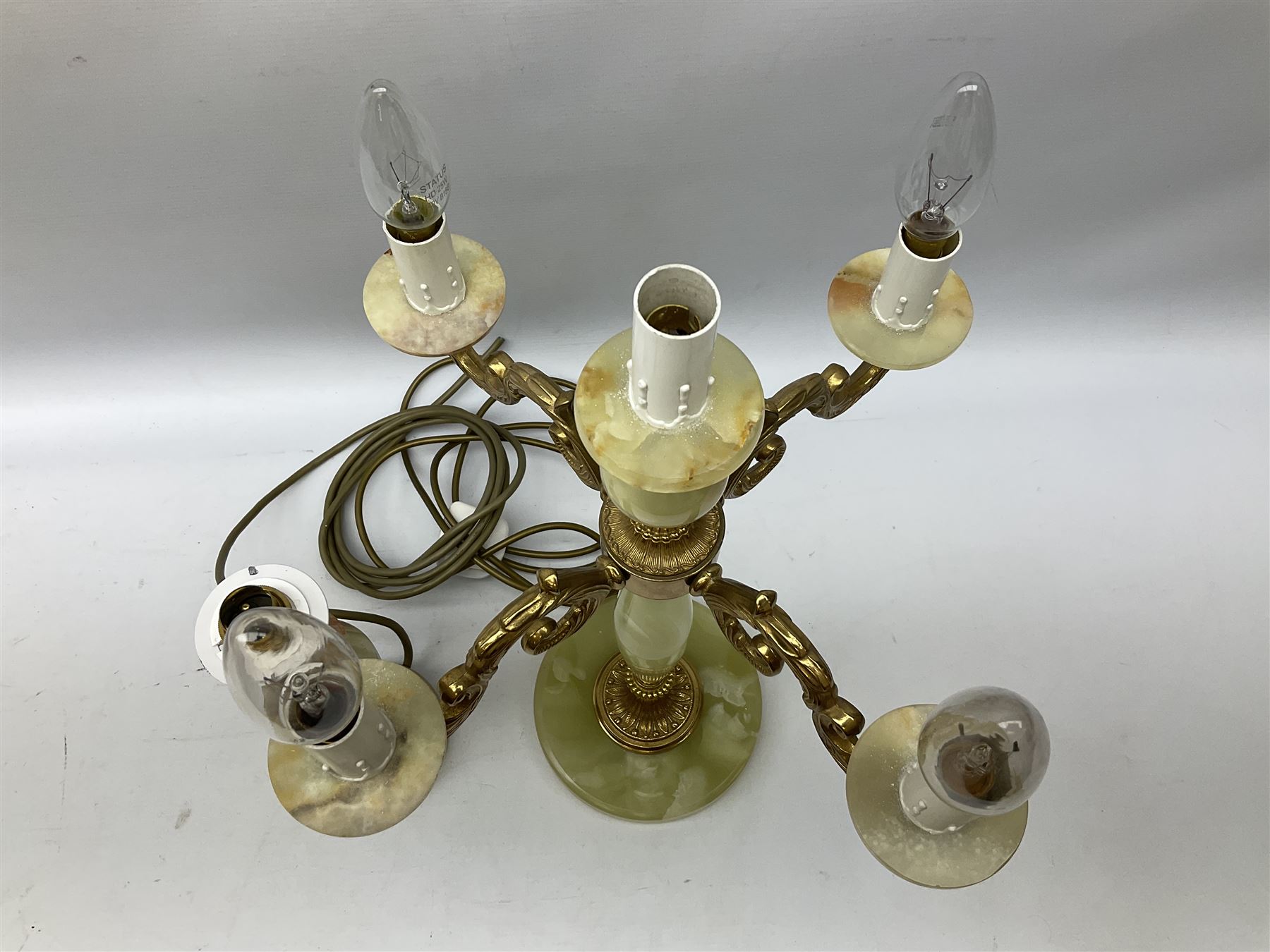  20th century gilt metal and onyx four branched candelabra upon a circular base, and onyx table lamp in the form of an urn, tallest example H48cm