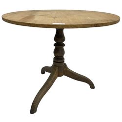 Early 19th century pine and elm tripod table; circular tilt-top over turned column and three splayed supports