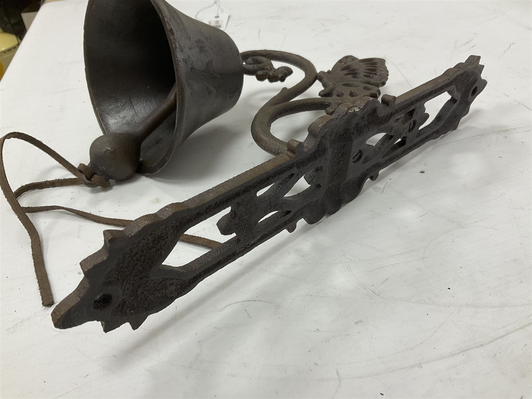 Cast iron exterior hanging garden bell with decorative butterfly bracket