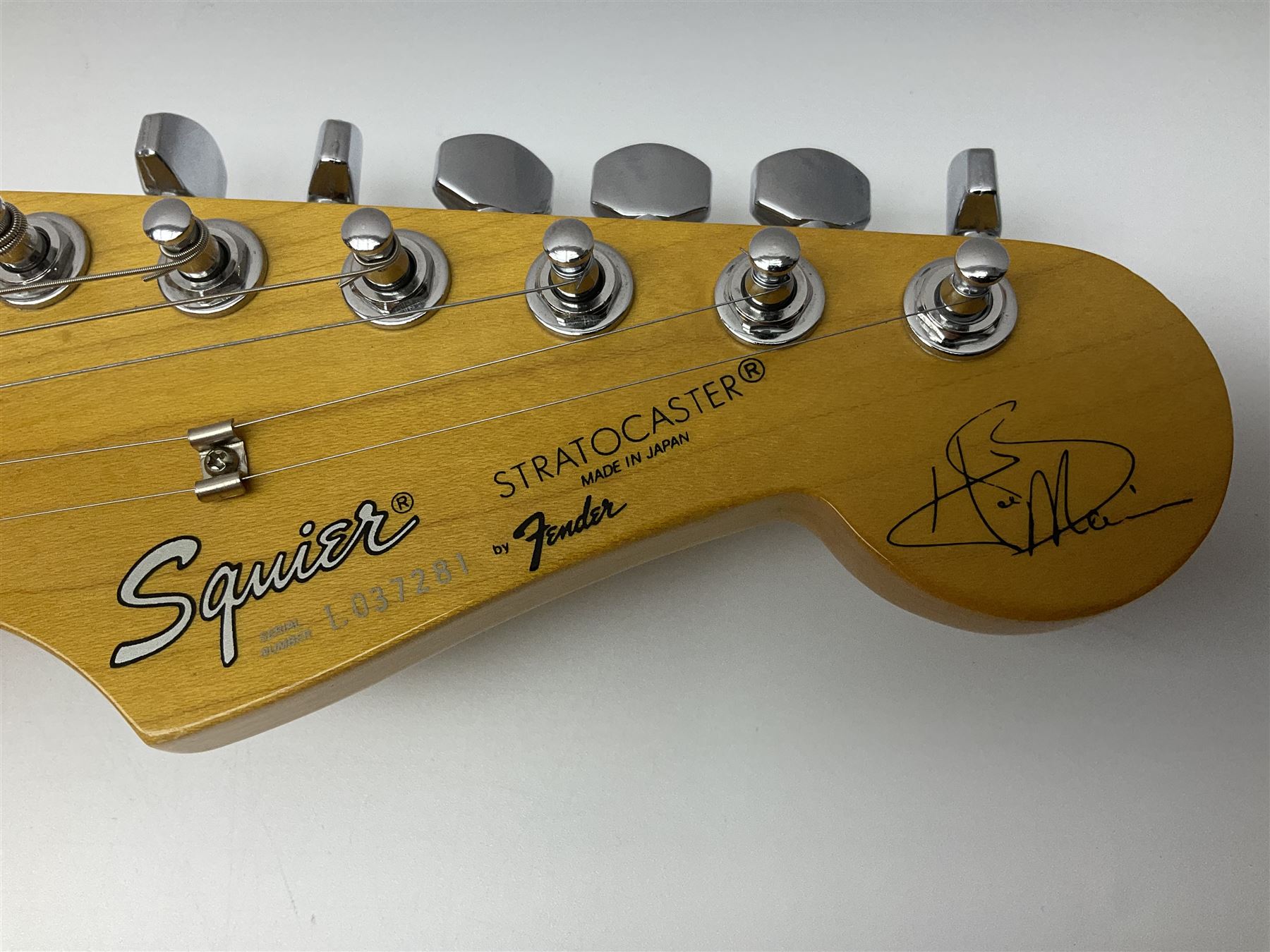 Japanese Squier Fender 'Hank Marvin' Stratocaster electric guitar, c1992, in Fiesta red with tremolo arm and facsimile signature decal; serial no.L037281, L98cm; in hard carrying case.