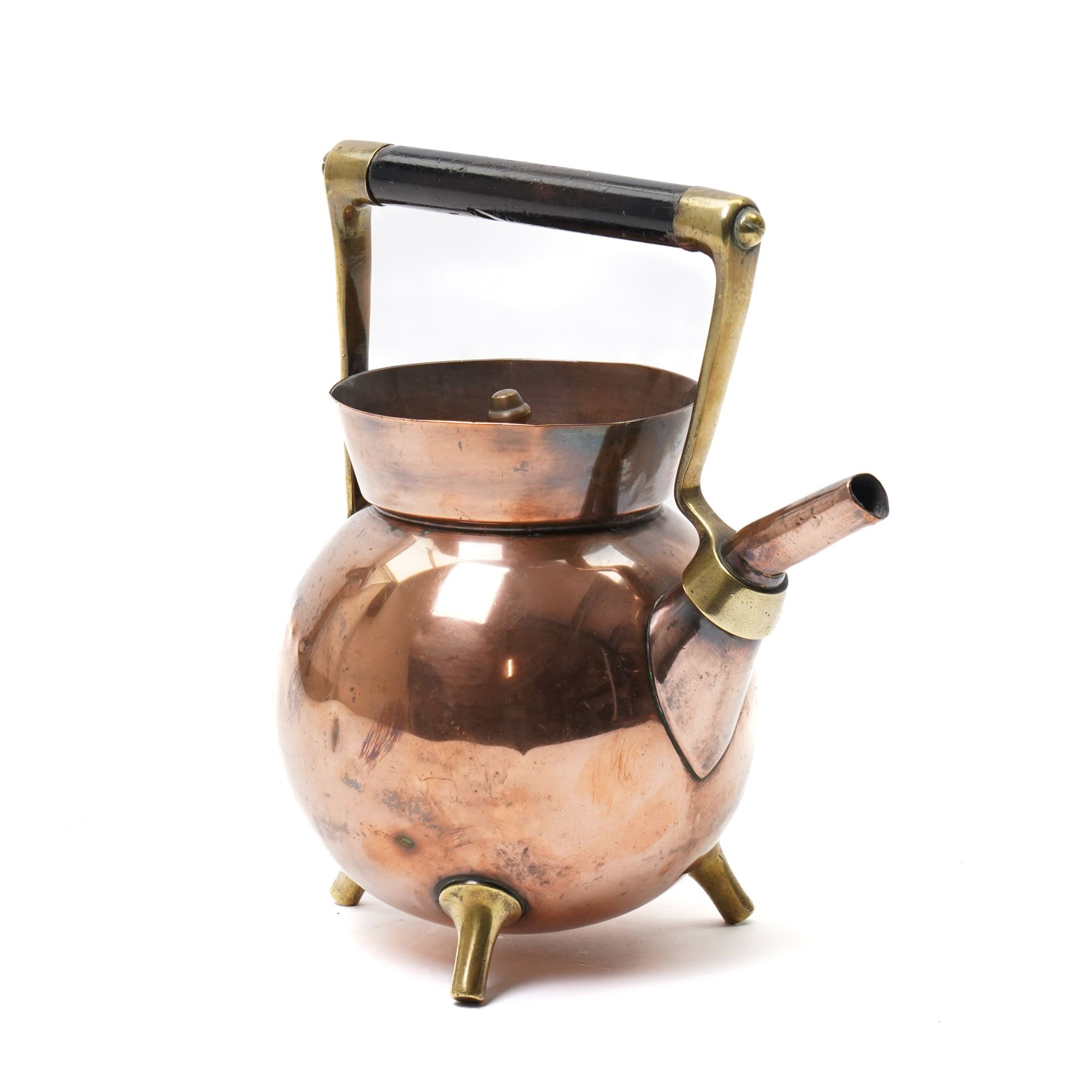 Copper teapot designed by Dr Christopher Dresser for Benham & Froud of bulbous form with brass and wood handle and three spur feet, impressed mark H24cm 