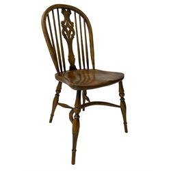 Set of four elm Windsor dining chairs, high hoop and stick back with shaped pierced splat, over shaped saddle seat, raised on ring turned supports joined by crinoline stretcher