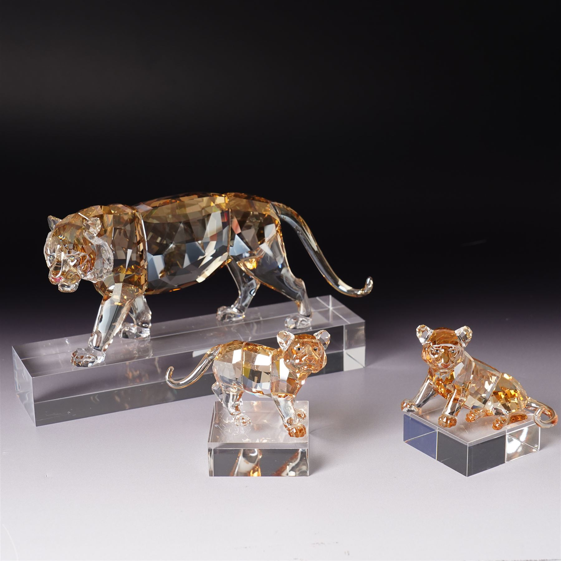 Swarovski, Endangered Wildlife, Tiger and two cubs, each with box, together with glass stands 